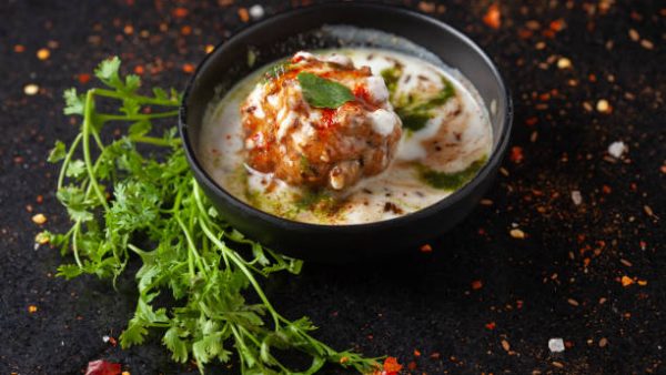 Chaat Dahi vada (AKA Dahi Bhalla, Doi Bora, mosaru vade, Dahi Bara, thayir vadai, perugu vada). Prepared by soaking vadas in thick curd (yogurt). Garnished with cumin and green fresh coriander