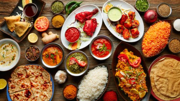 Assorted Indian recipes food various with spices and rice on wooden table